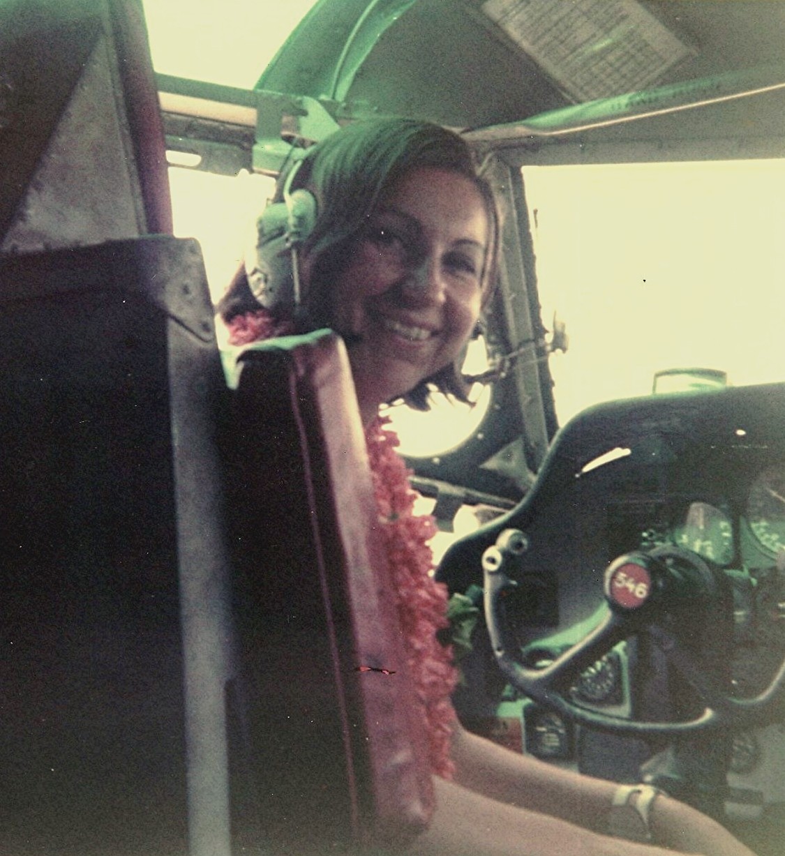 1968 DaNang, Vietnam, Pan Am Flight Attendant, Maureen VanLeeuwen, poses in the cockpit of a US military C123 during a crew transit.